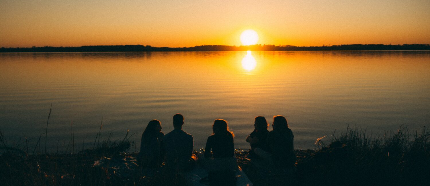 People gathered around a sunset