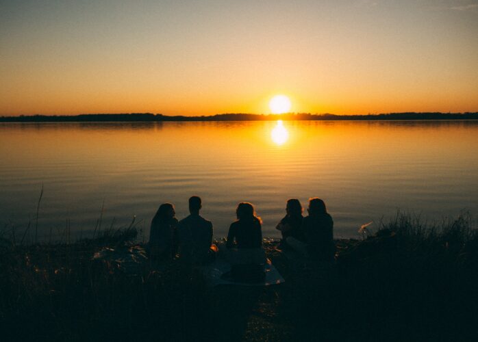 People gathered around a sunset